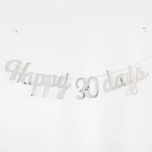 Silver letter banner featuring Happy 30 days text for baby milestone party decoration.
