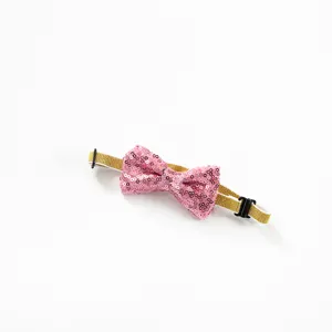 Pink sequin pet bow tie with adjustable gold elastic band, perfect for birthday party dogs.