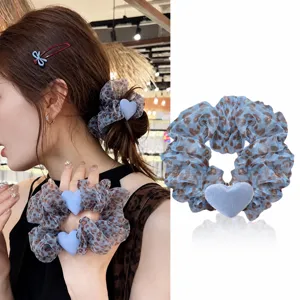 Blue leopard print hair scrunchie with heart charm, stylish hair accessory for women.
