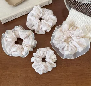 Detailed view of elegant floral lace hair scrunchies, soft mesh design for women and girls ponytail.