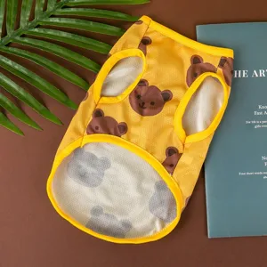 Detailed view of yellow mesh pet vest with cute bear print, breathable summer dog shirt.
