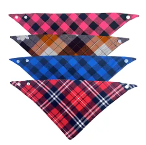 Close-up detail of classic plaid pet bandanas with secure snap buttons, assorted colors.