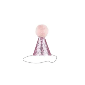 Macro detail of a pink glittery pet birthday party cone hat with a soft pom-pom