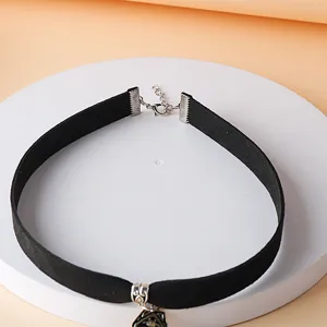 Close-up detail of black gothic choker necklace with silver alloy pendant and extension.