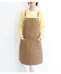 Canvas work apron with multi pockets and leather straps, ideal for coffee shop and kitchen use.