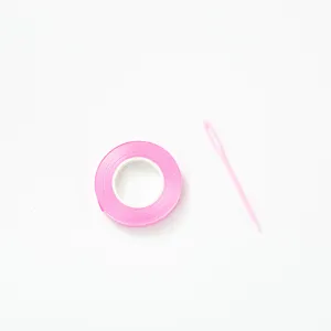 Pink ribbon roll with plastic yarn needle set for DIY craft, handmade sewing and party decoration.