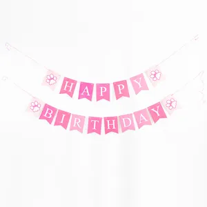 Pink happy birthday letter banner with cute paw prints for pet dog party decoration details.