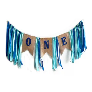 First birthday party burlap ribbon banner decoration detail, blue and cyan fabric.