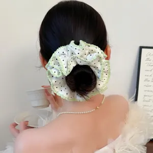 Sweet polka dot hair scrunchie with ruffled green edge, stylish Korean hair accessory for women.