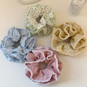 Detail shot of sweet double layer polka dot hair scrunchies set, elegant hair accessories.