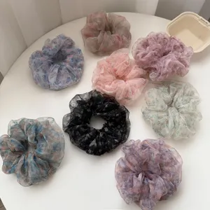 Detailed view of floral organza scrunchies with glitter, Korean style hair ties for women.