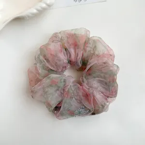Floral organza hair scrunchie detail view, sparkling rhinestone accent, soft daily hair tie.