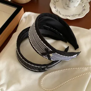 Black and white plaid and polka dot wide headband lace bow hair accessory detail shot
