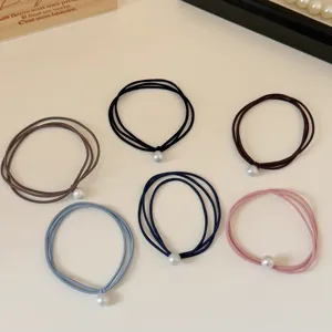 Set of six colorful elastic hair ties featuring a single elegant pearl decoration detail.