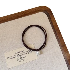 French minimalist pearl hair tie with brown elastic rope, elegant hair accessories for women.