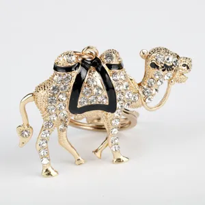 Close-up detail of glittering rhinestone gold camel animal keychain and bag charm ornament.