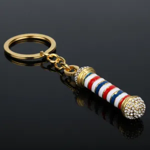 Elegante portachiavi da barbiere color oro con strisce rosso bianco blu e strass luminosi.