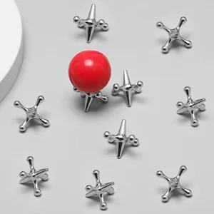 Detailed shot of metal jacks game set with red ball, perfect for desktop fun and relief.