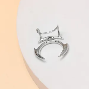 Close-up detail shot of the silver punk non-piercing lip cuff with unique spiky gothic design.