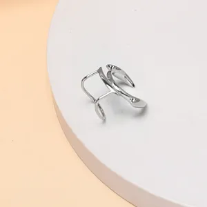 Detail view of a punk style silver metal lip cuff, showing the unique abstract minimalist design.