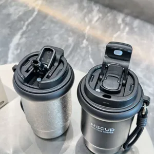 Detailed view of portable stainless steel double drink coffee mugs with straw for office.