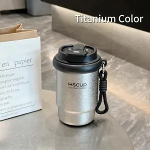 Detail shot of the stainless steel portable coffee cup with titanium color finish and lid.