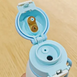 Stainless steel vacuum insulated water bottle detail view lid and straw component close up