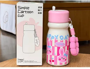 Creative cute pink vacuum insulated water bottle with straw and portable silicone strap for students.