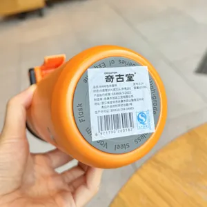 Detailed bottom view of portable stainless steel spray water bottle showing specification label.
