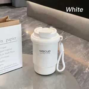 Portable travel coffee cup detail view, white silicone collapsible mug with carrying strap.