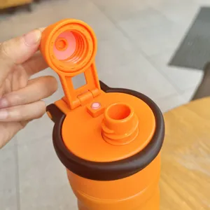 Close-up view of the orange sports water bottle lid detail showing the open flip cap mechanism.