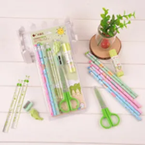 Green stationery set including pencils, scissors, glue stick, and eraser for school and office use.