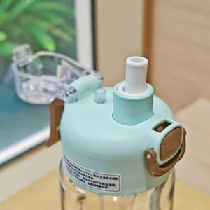 Close-up of portable sports water bottle lid with straw mouthpiece and spray function design.