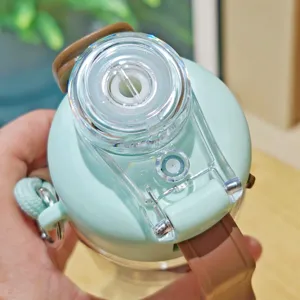 Portable sports water bottle cap detail showing dual drink lid and brown strap design.