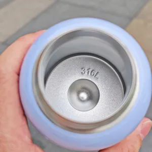 Close-up detail view of the stainless steel inner liner inside a cute kids vacuum thermos cup