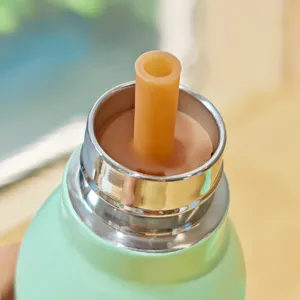 Stainless steel thermos cup detail featuring silicone straw and smooth metallic rim finish.