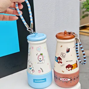 Detailed shot of cute stainless steel thermos cups with cartoon dog prints and beaded lanyards.