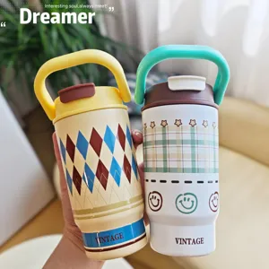 Stainless steel portable insulated coffee cup with cute plaid pattern and convenient handle design.