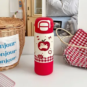 Detailansicht der niedlichen Cartoon Edelstahl Thermosflasche mit Hundemotiv und Deckel.