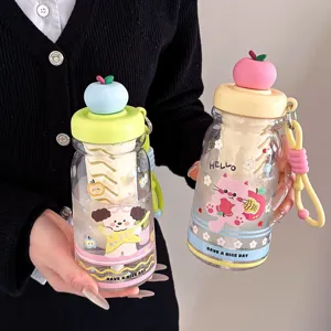 Close-up detail of cute apple lid plastic water bottle with tea compartment and cartoon design.