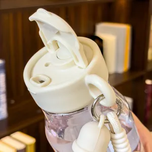 Portable plastic water cup with cute bear design, dual-drink straw lid and hanging strap.