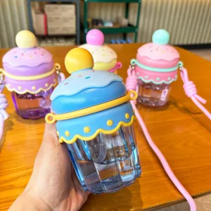 Cute cartoon cake water bottle with straw and strap, portable plastic drinkware for kids.