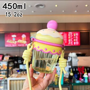 Cute cupcake shaped water bottle detail shot, portable straw cup with yellow strap.