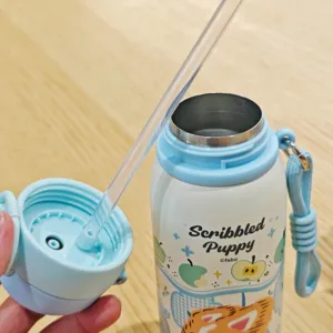 Stainless steel insulated water bottle with straw and cute puppy cartoon design, detail view.
