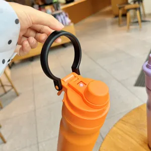 Detailed close-up view showing the portable outdoor sports water bottle lid and handle.