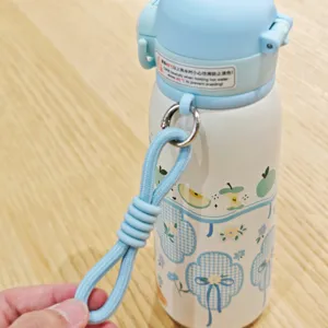 Stainless steel vacuum insulated water bottle with strap and cute apple floral pattern detail.