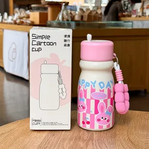 Cute pink vacuum insulated water bottle with cute rabbit pattern, straw and portable strap.