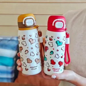 Stainless steel vacuum insulated water bottle with cute heart pattern and portable strap.