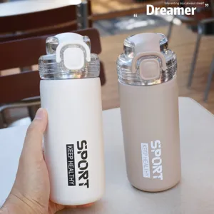 Double wall vacuum insulated sports water bottle with straw lid and portable handle design.
