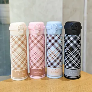 Detailed shot of portable stainless steel vacuum insulated water bottle with stylish plaid pattern.